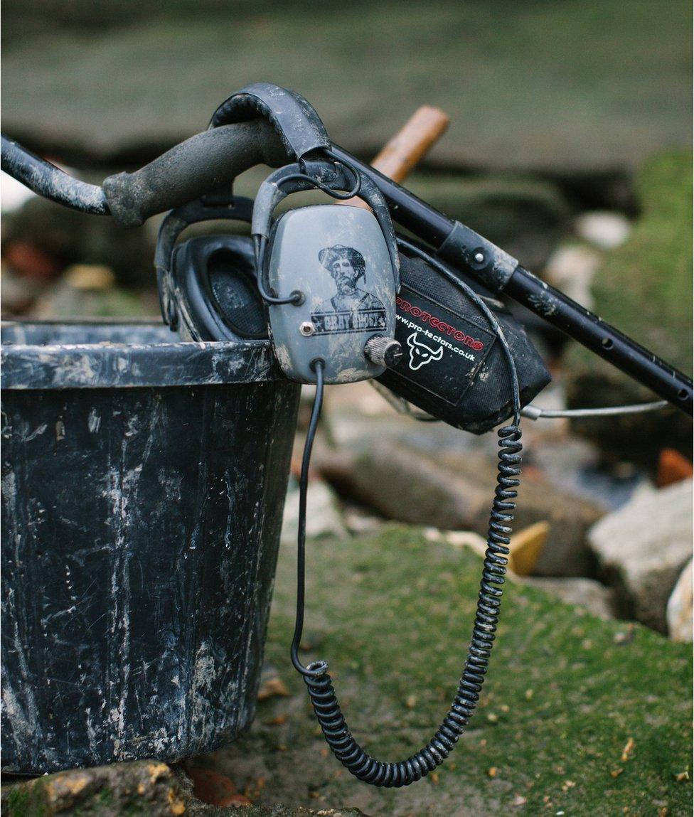 A bucket and metal detector