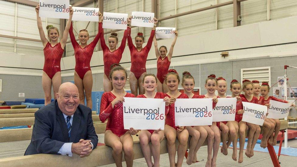 Joe Anderson with young gymnasts holding Liverpool 2026 placards