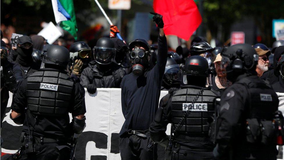 Counter-demonstrators are held back by police during a rally in Portland, 4 August 2018