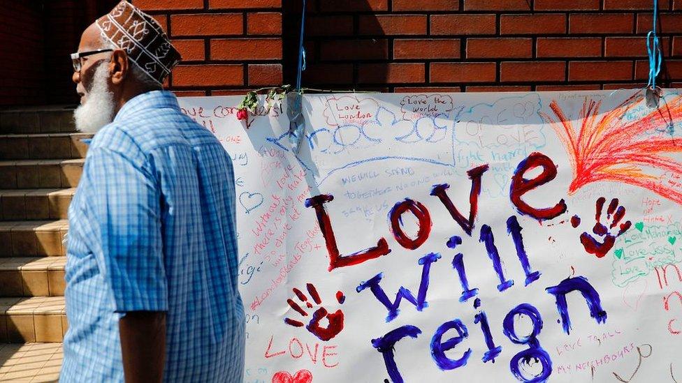 Man walks past sign at Finsbury Park Mosque