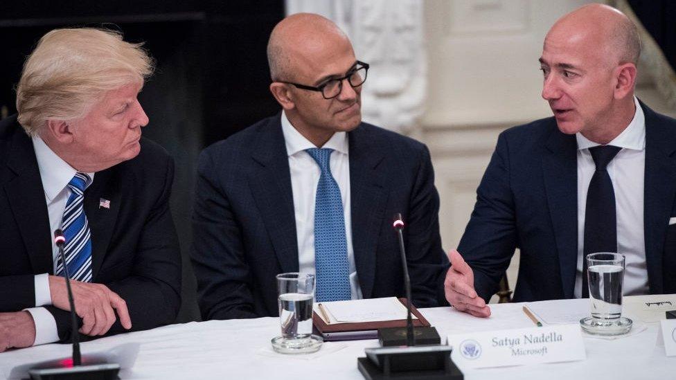 President Donald Trump speaks with Satya Nadella, Chief Executive Officer of Microsoft, and Jeff Bezos, Chief Executive Officer of Amazon during an American Technology Council roundtable in the State Dinning Room at the White House in Washington, DC on Monday, June 19, 2017.