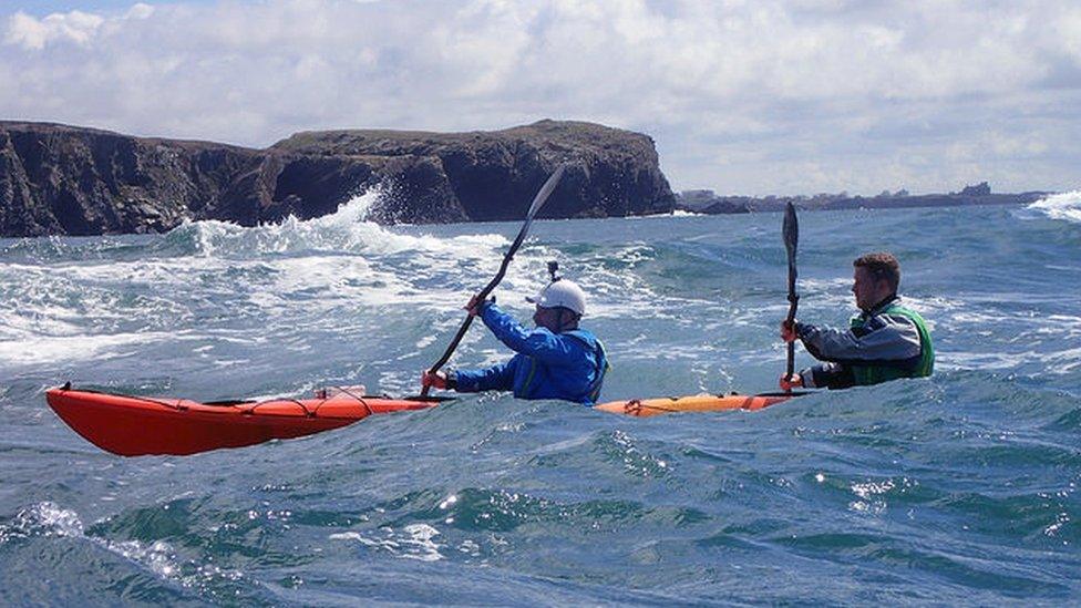 the pair kayaking in the sea