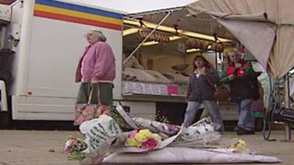 A floral tribute left in the market place, after the shooting in 1995