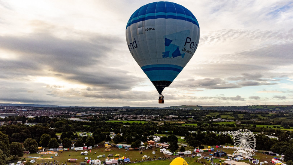 A blue hot air balloon in the sky