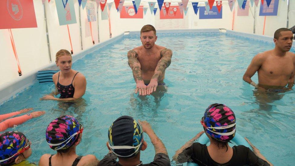 children-in-swimming-pool-learning-from-Olympic-swimmers.