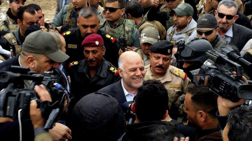 Iraqi Prime Minister Haider al-Abadi walks through central Ramadi (29 December 2015)