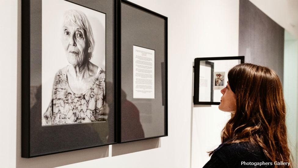 Young woman looking at Black and White photo