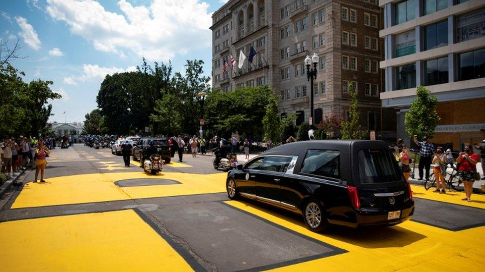 The casket of civil rights pioneer John Lewis, who died July 17, drives on 16th Street, renamed Black Lives Matter Plaza, near the White House, in Washington