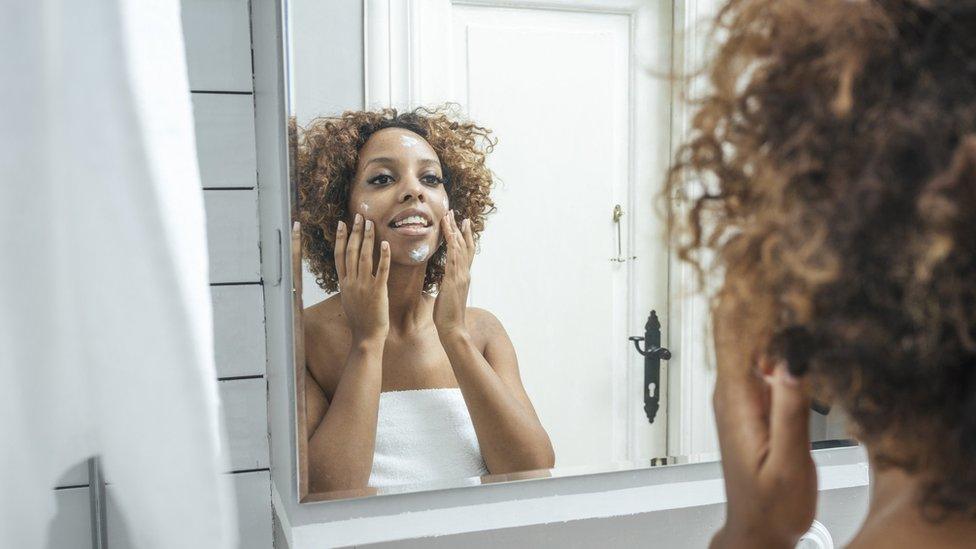 Woman using face cream.