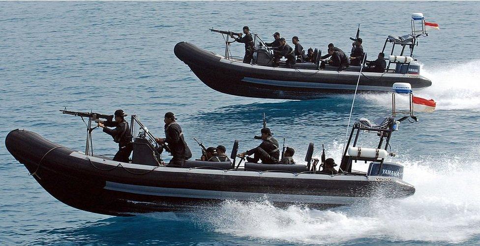 Indonesian marines sail armed speed boats during a simulation of the interception of a pirate ship - part of joint exercises with US navy seals off Sepa island, northern Jakarta, 27 July 2006.