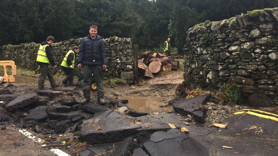 Jon Holdsworth of Patterdale Hall Estate inspects flood damage outside the estate near the village of Glenridding in Cumbria