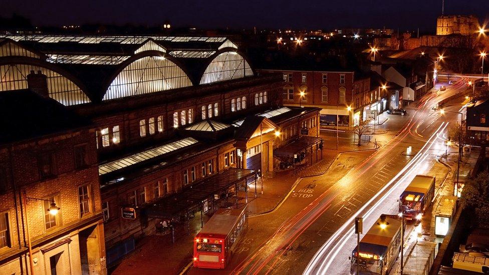 Aerial view of bus driving by Carlisle station