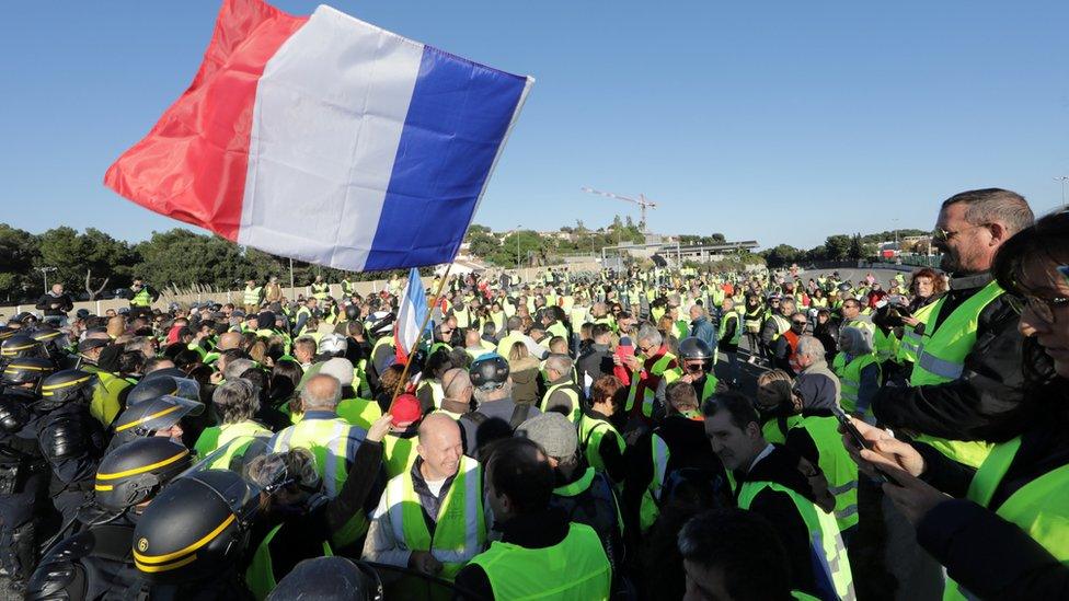 police attend as protesters block a motorway in Antibes, southern France