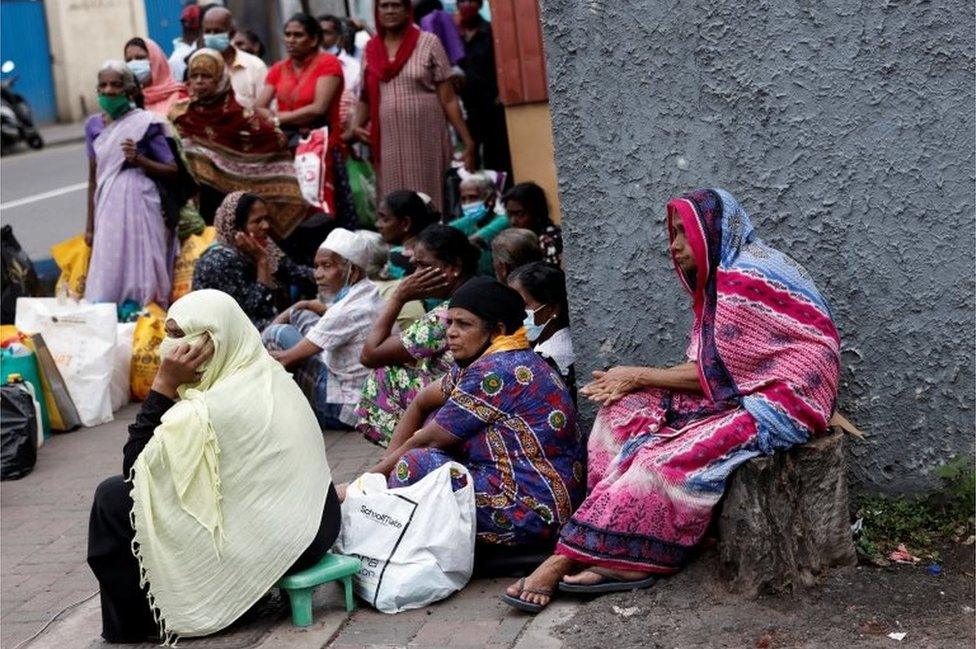 People wait in a line on a pavement near a distributor to buy kerosene oil for their cookers due to domestic gas shortage, amid the country"s economic crisis, in Colombo, Sri Lanka, May 24, 2022.