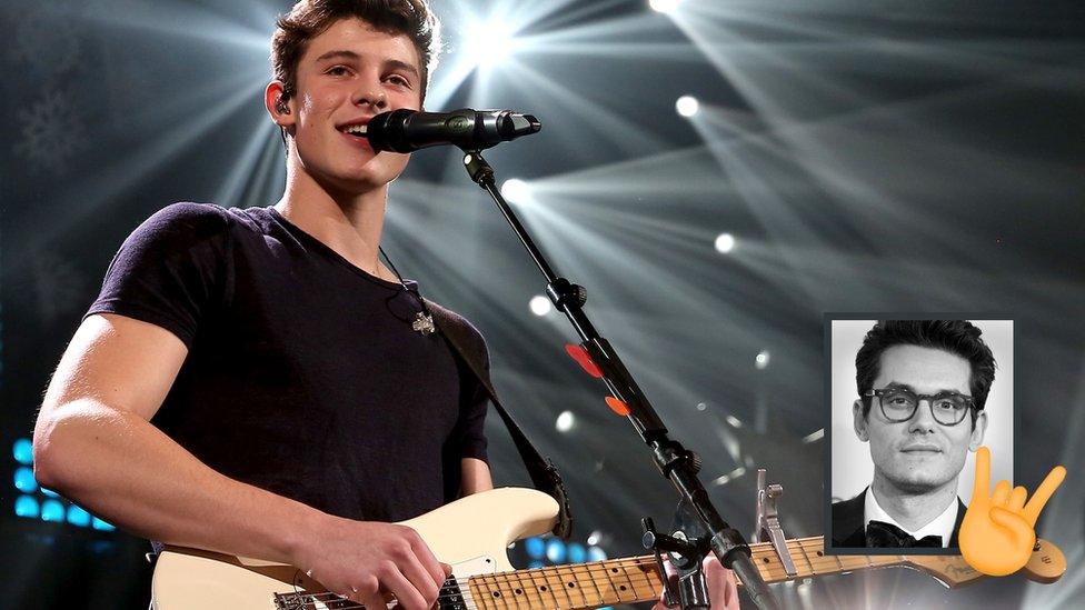 Shawn Mendes sings into a microphone on stage while holding a guitar, inset shows John Mayer with a 'rock on' emoji.