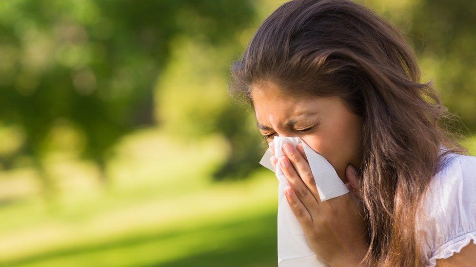 Image of a women sneezing