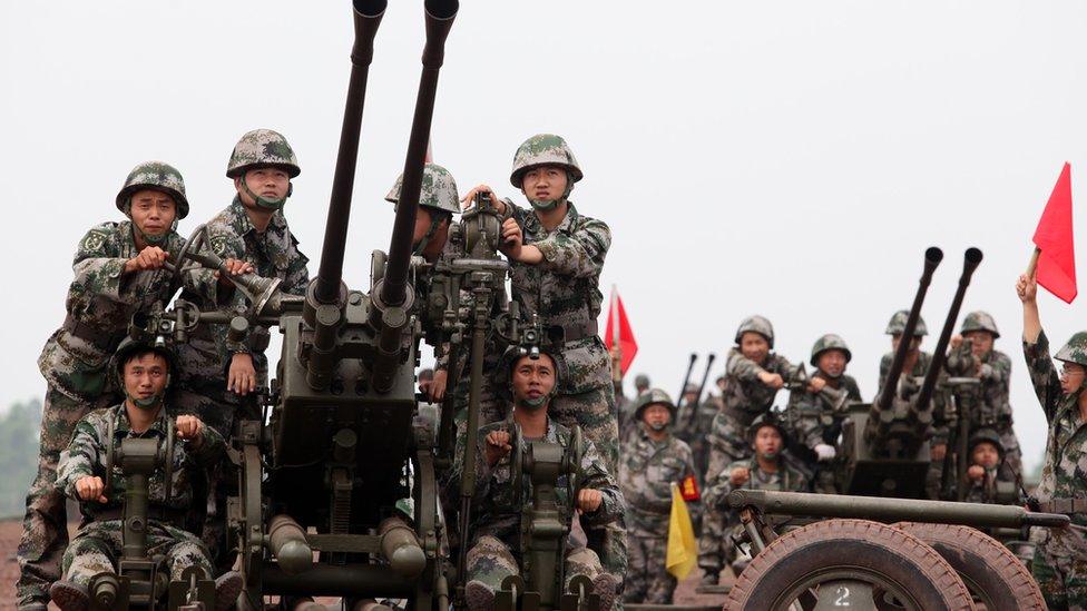 Chinese troops practice with anti-aircraft guns during drills