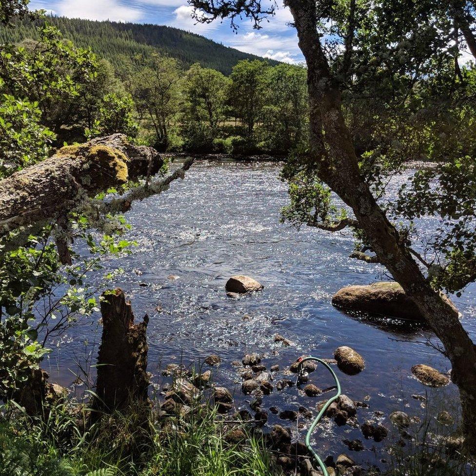 Bruce McConachie pumps water from the River Spey