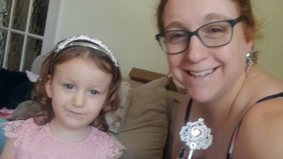 Mother and girl dressed in formal clothes as for a wedding