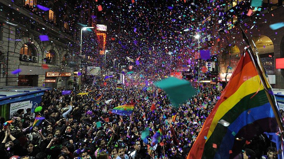 People dance and cheer during the annual Gay Pride Parade in Montevideo, on September 30, 2011