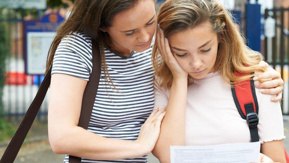 A girl and her mum look sad about her results