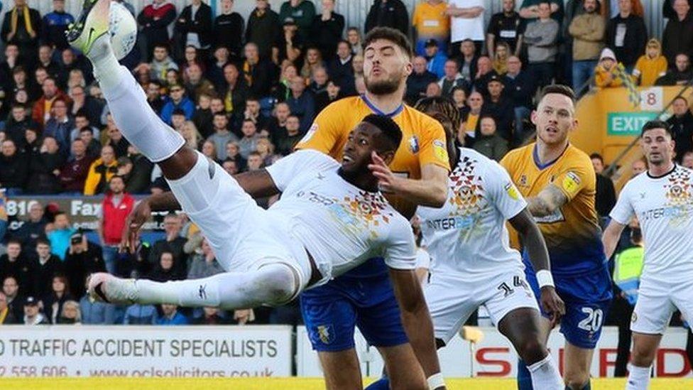 Jamille Matt of Newport County tries to get a shot at goal