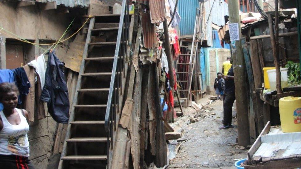 A woman standing outside her home in the Mukuru slum