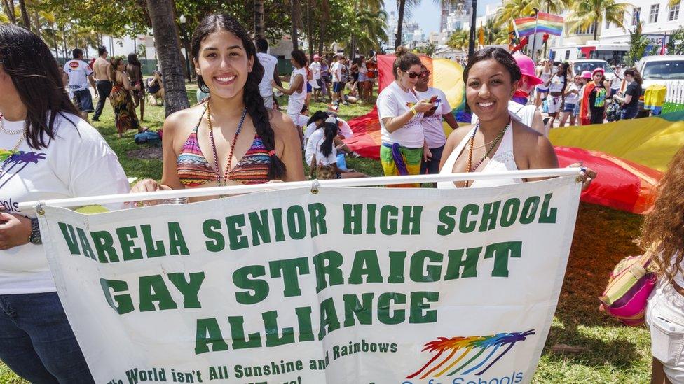 Students from a Florida school hold up a sign in support of their GSA