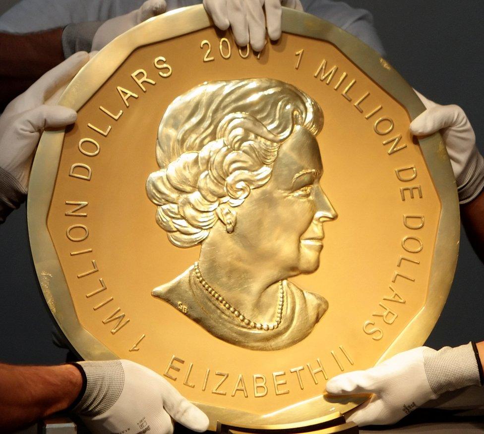 Picture taken in Vienna, Austria on June 25, 2010 shows experts of an Austrian art forwarding company holding one of the world's largest gold coins, a 2007 Canadian $ 1,000,000 "Big Maple Leaf". An identical coin was stolen from Berlin's Bode Museum on March 27, 2017.