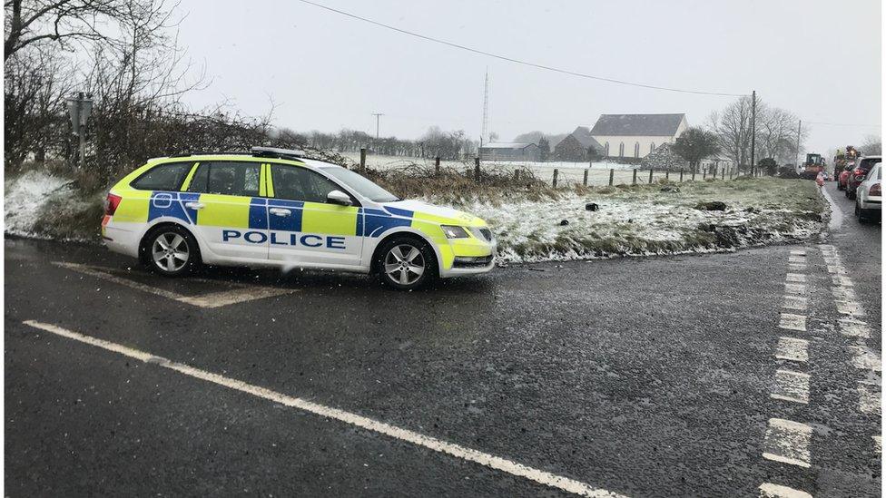 A police car parked near the scene of the crash on the Moyarget Road