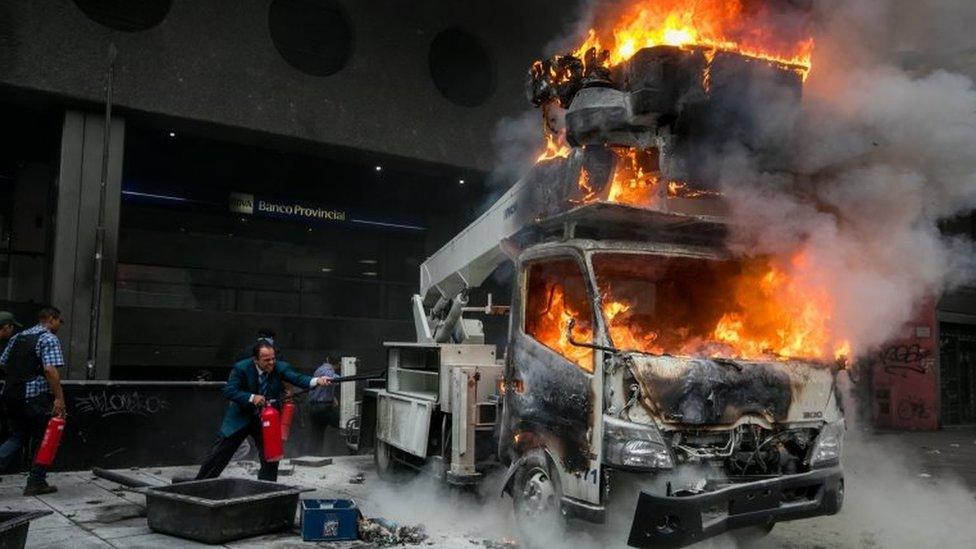 People try to extinguish a truck on fire during a protest in Caracas, Venezuela, 07 June 2017.