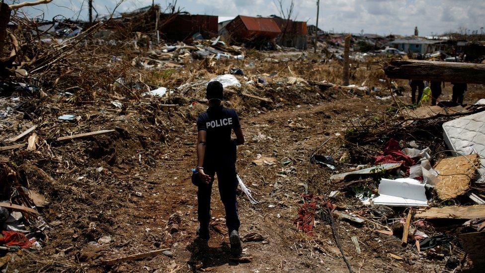 A police officer searches for the dead in the Abaco Islands