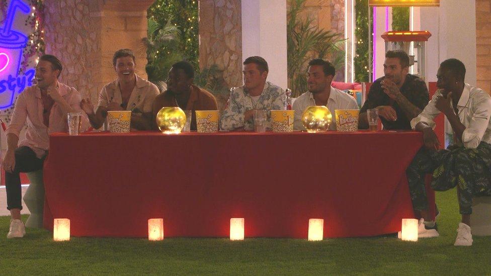 The male contestants on movie night