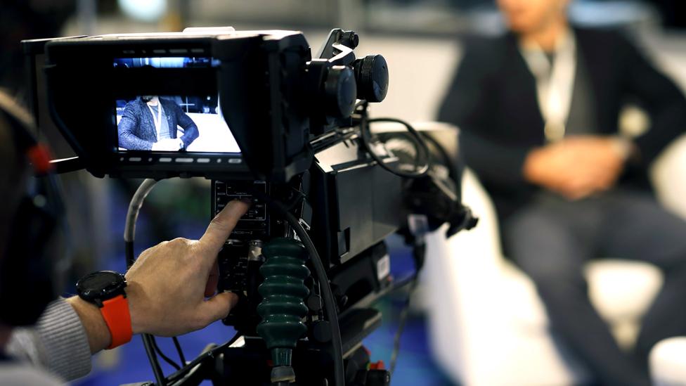 A TV camera films a programme