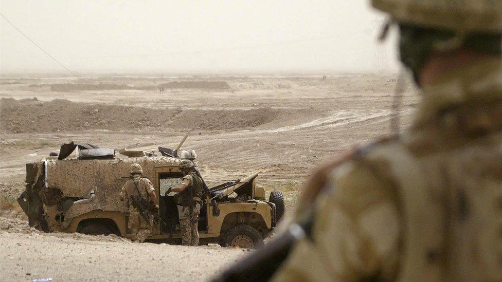 British troops inspect a Snatch Land Rover following a fatal roadside bombing in Basra, Iraq in September 2006