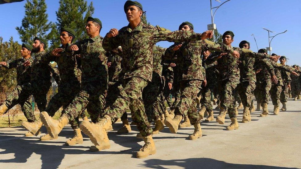 A file photo from 2018 shows newly-graduated Afghan National Army (ANA) cadets march during a graduation ceremony at the ANA training centre in Herat province