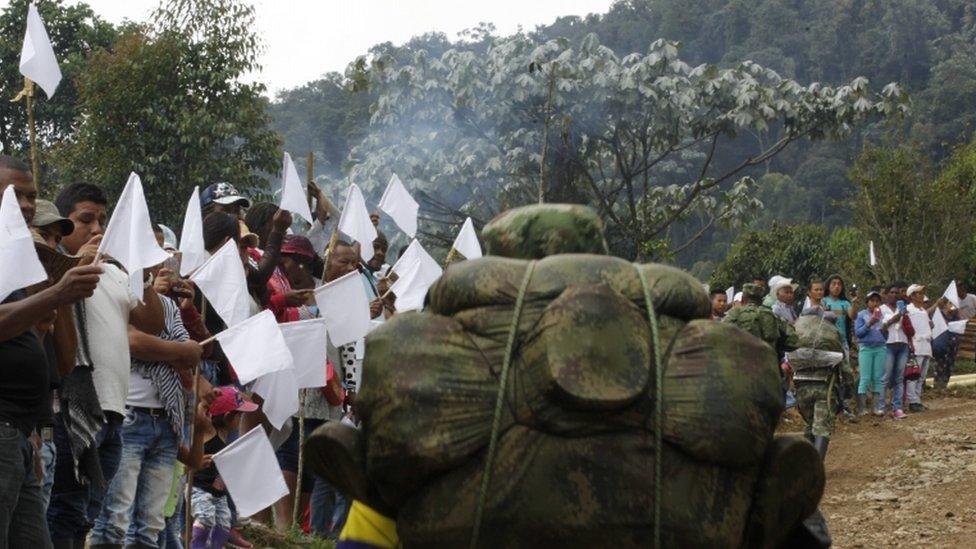 Residents wave white flags as Farc rebels march past in Cauca province, in Colombia, on 31 January 2017.