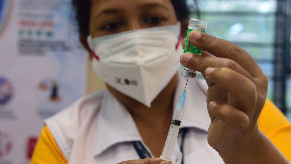 A health worker prepares a syringe in the Indian state of West Bengal