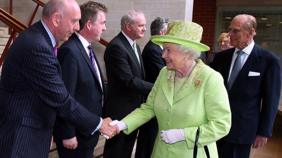 The Queen shakes hands with Peter Sheridan from Co-operation Ireland as Prince Philip meets Northern Ireland Deputy First Minister Martin McGuinness at the Lyric Theatre in Belfast in 2012