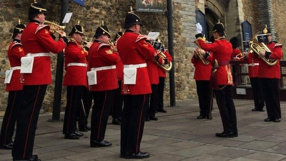 Members of the 1st Battalion Welsh Guards band playing outside Cardiff Castle