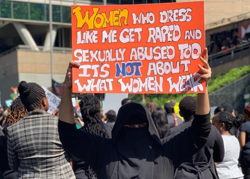 Woman holding up a sign