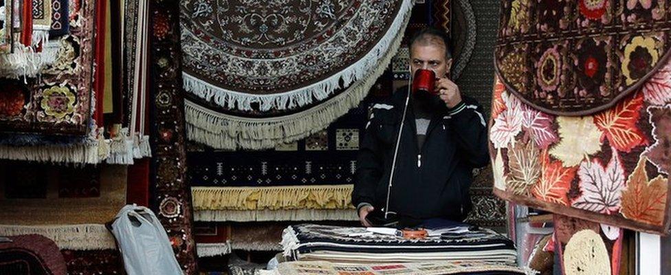 An Iranian shopkeeper at a stand in a market in Tehran, Iran, 5 November 2018