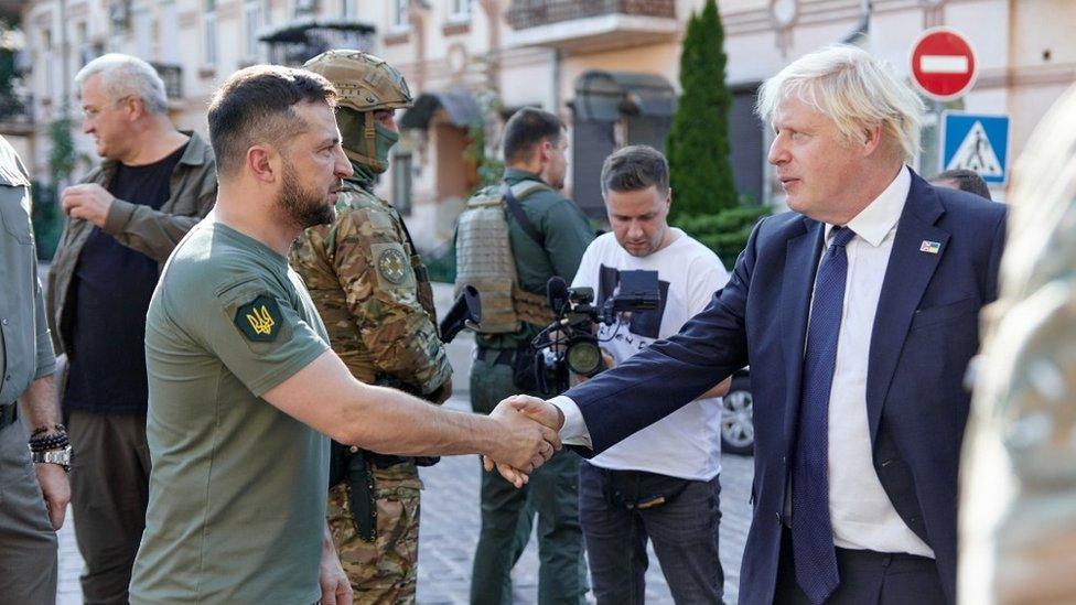 Volodymr Zelensky shakes hands with Boris Johnson