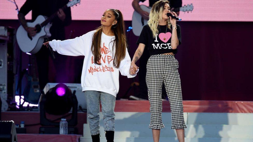 In this handout provided by 'One Love Manchester' benefit concert (L) Ariana Grande and Miley Cyrus perform on stage on June 4, 2017 in Manchester, England. Donate at www.redcross.org.uk/love