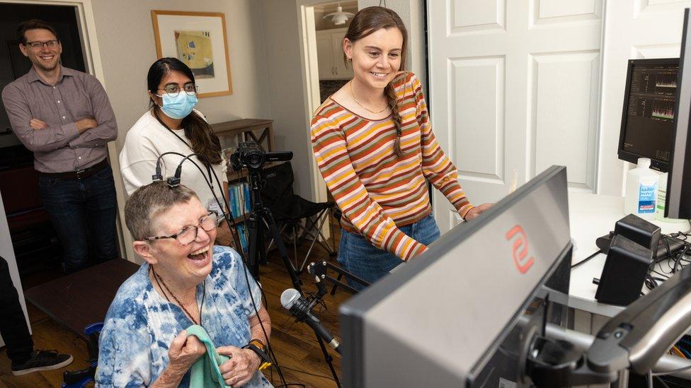 Pat Bennett with researchers training the brain interface to recognise her speech attempts