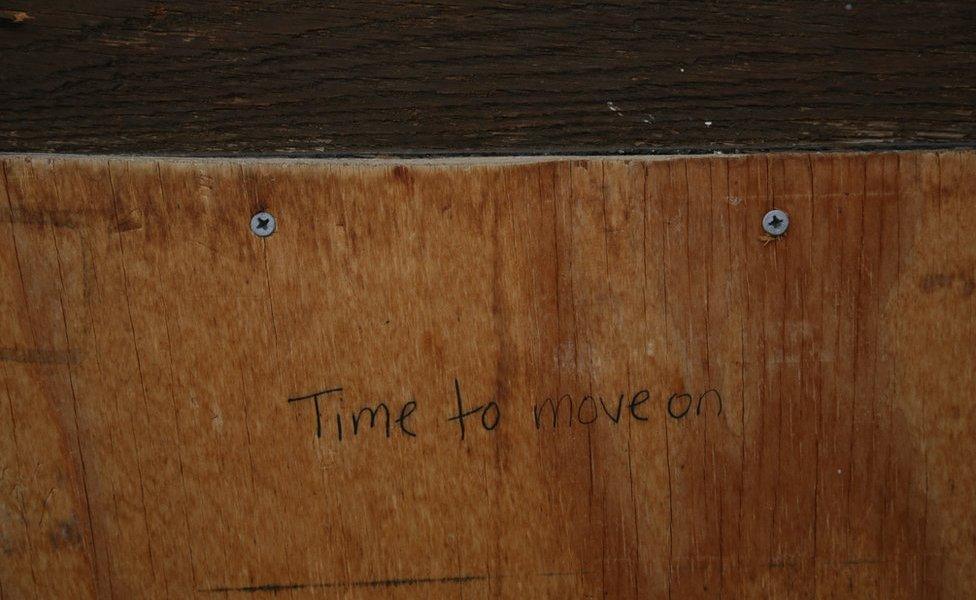 A message scrawled on the front door as the police cleared out the church