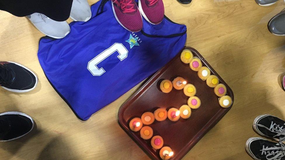 A netball bib for the "centre" position and cup cakes in the shape of the number 2.