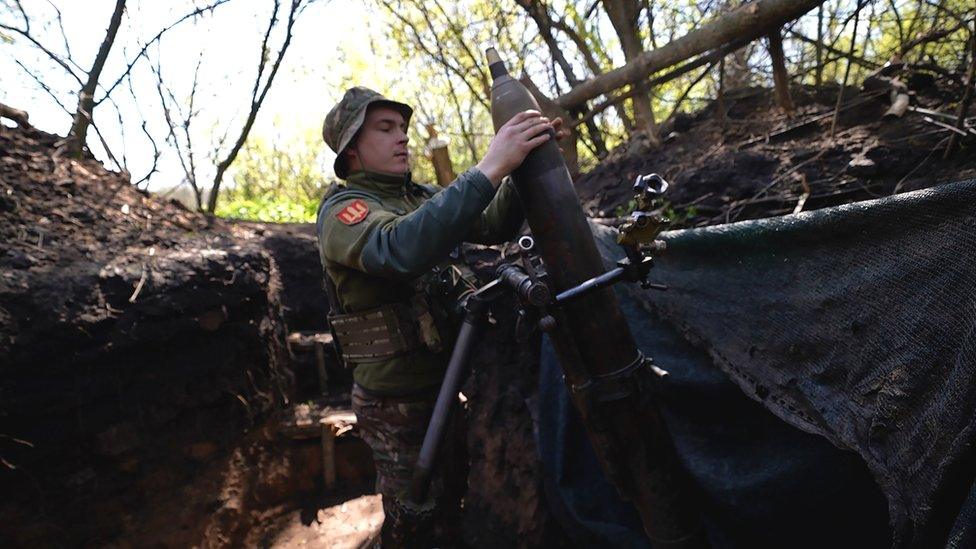 A 120mm mortar is loaded into a launching device in Eastern Ukraine