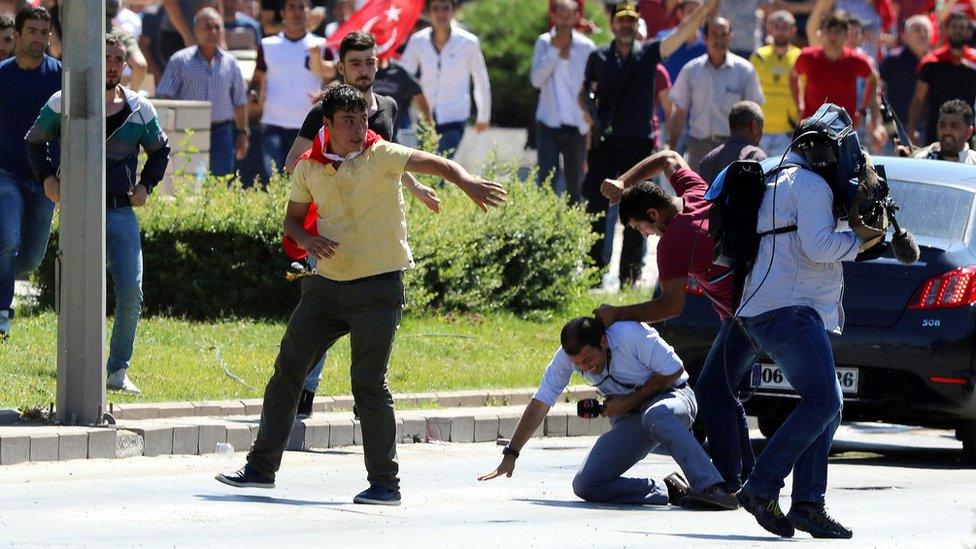 Turkish journalists are attacked by supporters of President Recep Tayyip Erdogan at a protest following the coup attempt