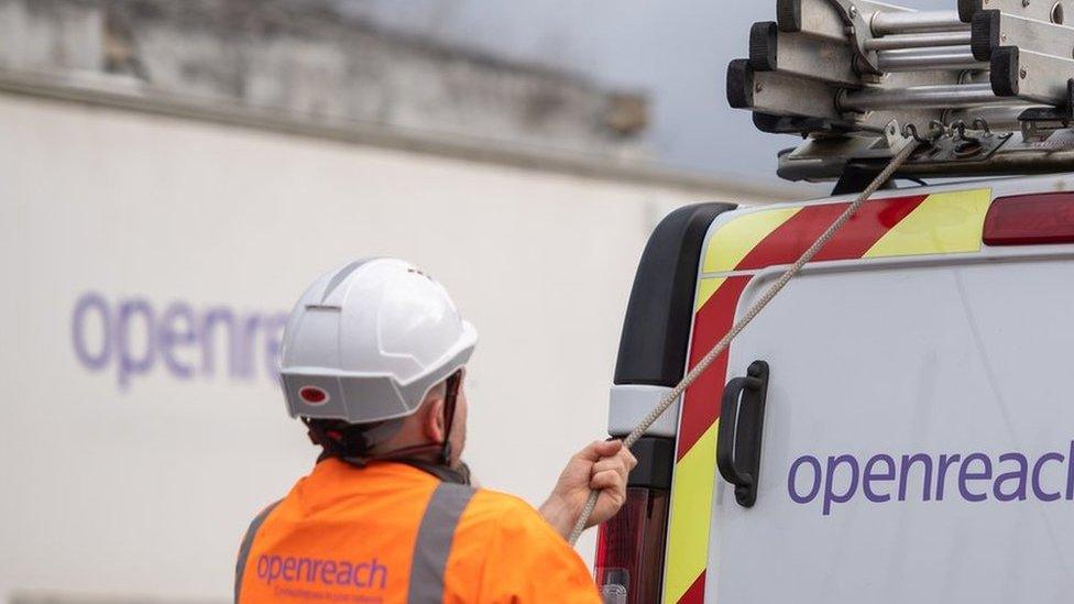 An Openreach engineer loading a van